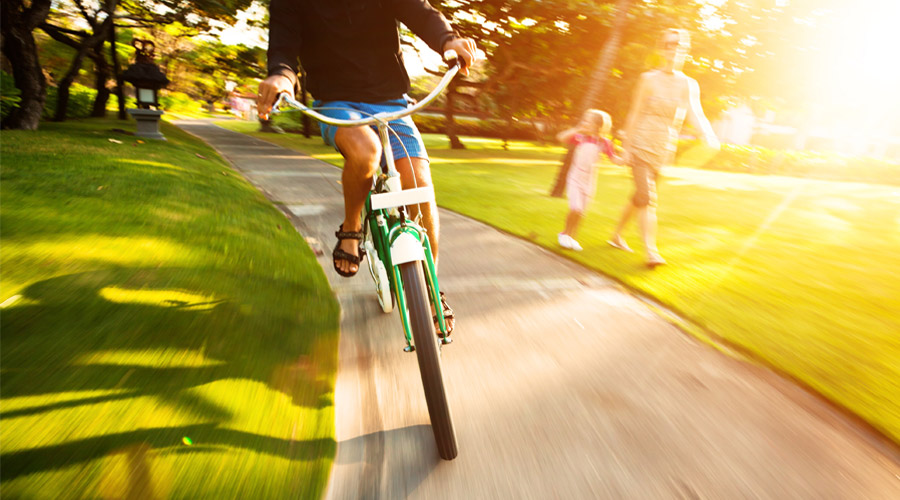 Biking on the sidewalk during sunset