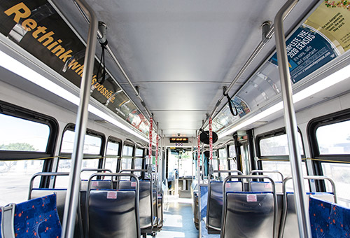 Empty bus looking from the back to the front of the bus